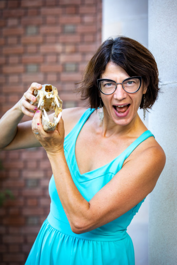 Elise Gornish holds a skeletal skull outside Forbes Hall on UA main campus